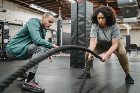 Male trainer with woman exercising.