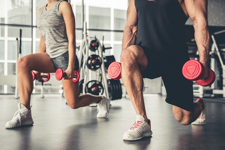 Two people in a squat with weights.